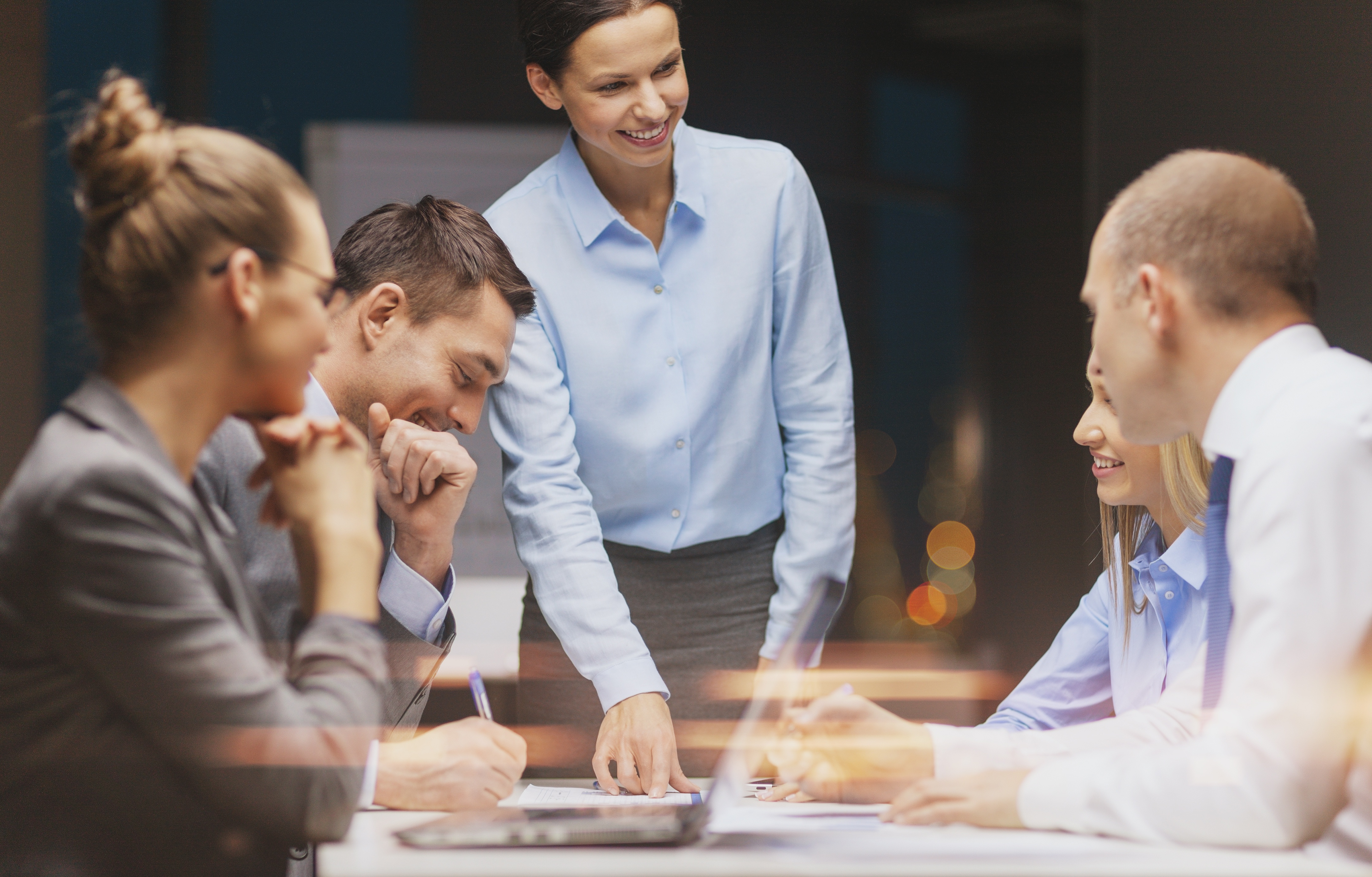 business, technology and office concept - smiling female boss talking to business team